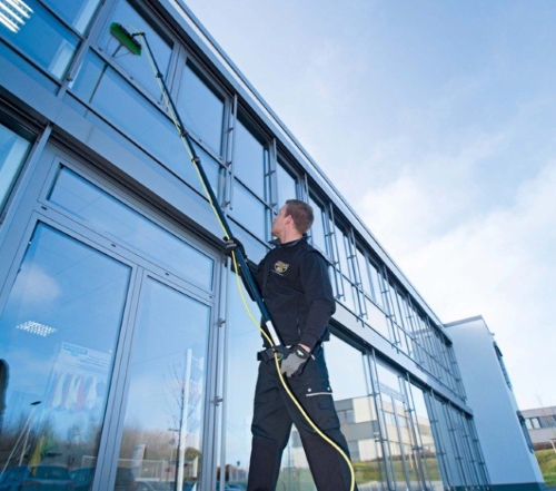 man cleaning using window cleaning equipment
